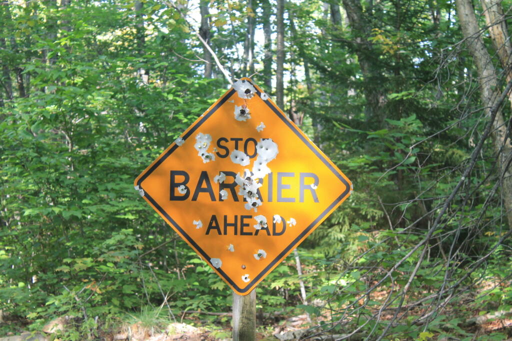 Photo: Well Shot Up Sign at New Squaw Lake Barrier Photo: Well Shot Up Sign at New Squaw Lake Barrier